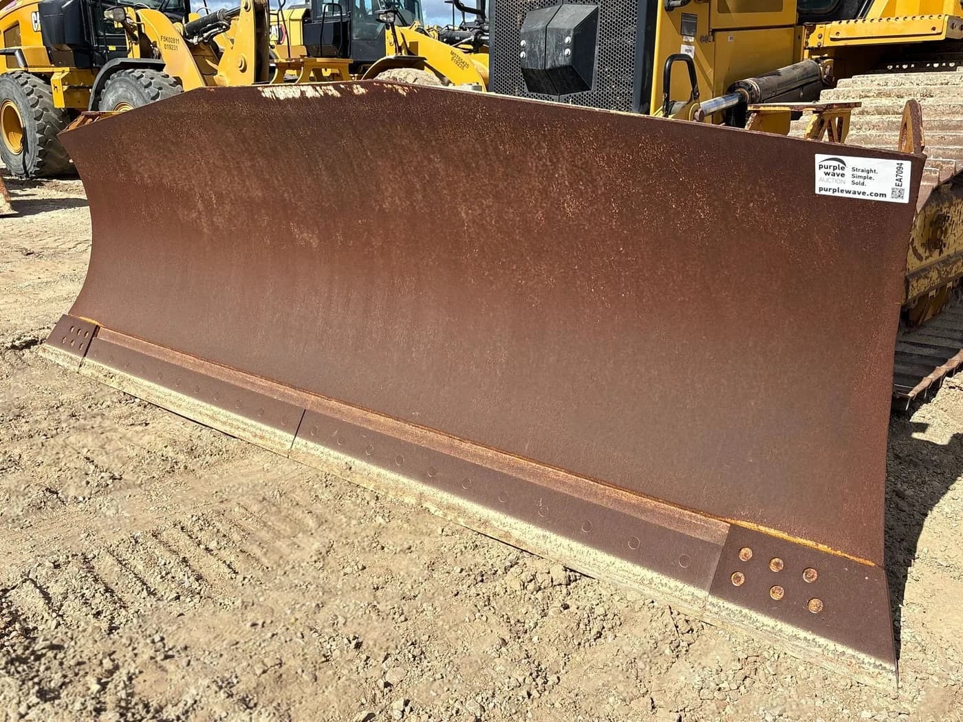 Close view of the blade wear surface on a Caterpillar D6 LGP dozer